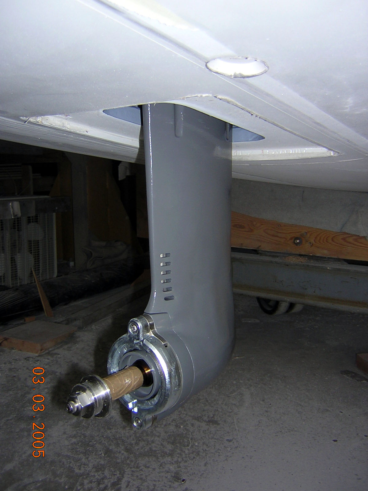 On the left, Tony gets the motor and saildrive properly lined up, and on the right, the